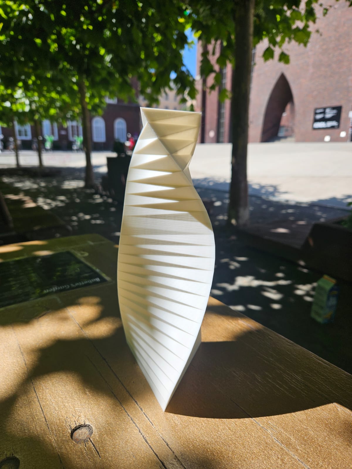 A WindVase with a triangular base in daylight